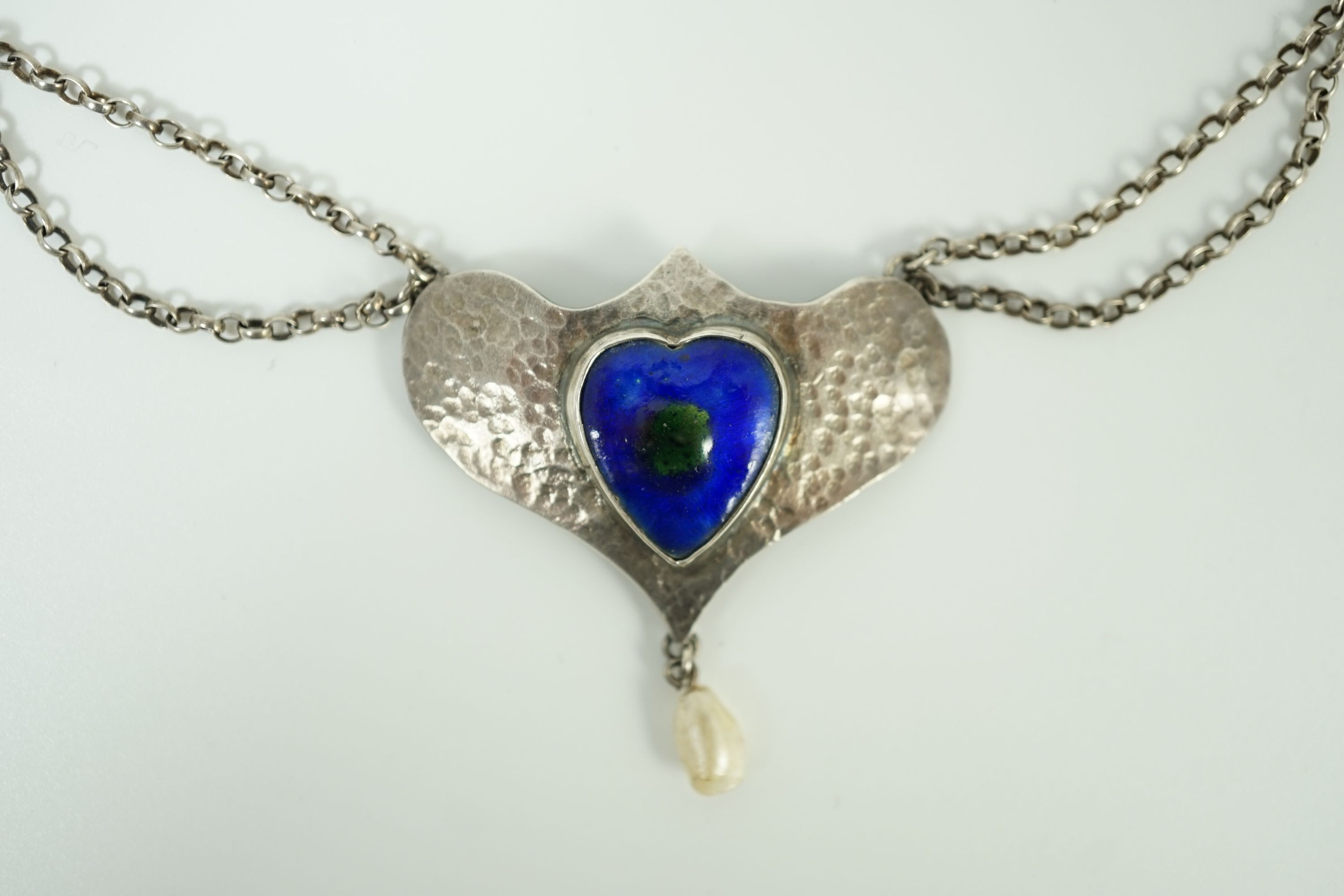 A stylish early 20th century sterling, enamel and baroque drop pearl set necklace